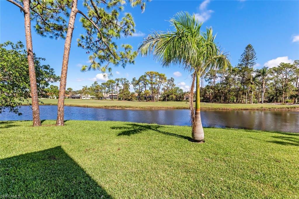 555 Augusta Boulevard, Unit 36 Naples, FL 34113 - Photo 2 of 25 a view of a lake with a yard