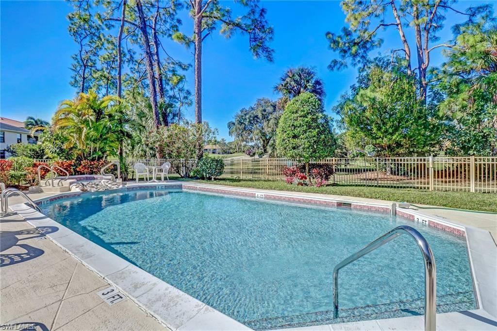 555 Augusta Boulevard, Unit 36 Naples, FL 34113 - Photo 25 of 25 a view of a swimming pool with a yard
