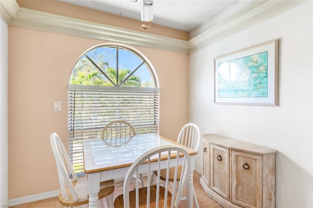 555 Augusta Boulevard, Unit 36 Naples, FL 34113 - Photo 6 of 25 a view of a dining room with furniture and a window