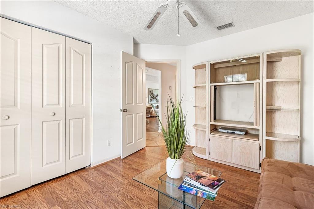 555 Augusta Boulevard, Unit 36 Naples, FL 34113 - Photo 9 of 25 a living room with furniture and a potted plant