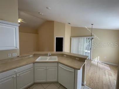 a kitchen with a sink and a refrigerator