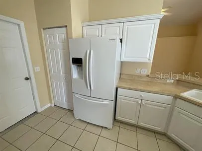 a white refrigerator freezer sitting inside of a kitchen