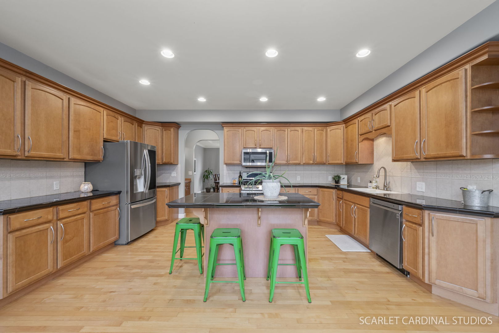 716 Cornwall Circle Sugar Grove, IL 60554 - Photo 5 of 29 a large kitchen with stainless steel appliances granite countertop a stove top oven a sink dishwasher and cabinets with wooden floor