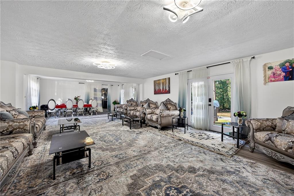4673 Arrowhead Trail Southwest Lilburn, GA 30047 - Photo 11 of 28 a living room with furniture and a large window