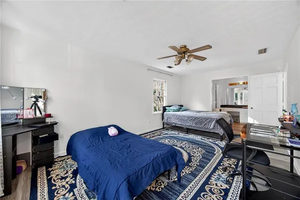 a bed room with a bed and a chandelier