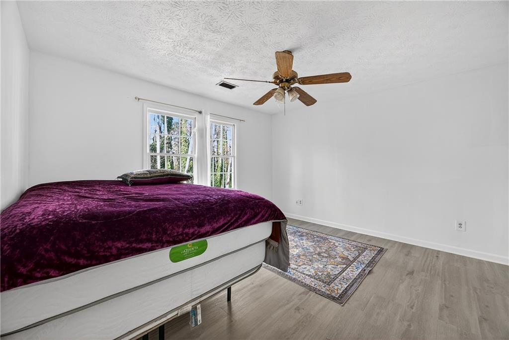 4673 Arrowhead Trail Southwest Lilburn, GA 30047 - Photo 20 of 28 a bedroom with a bed and a window