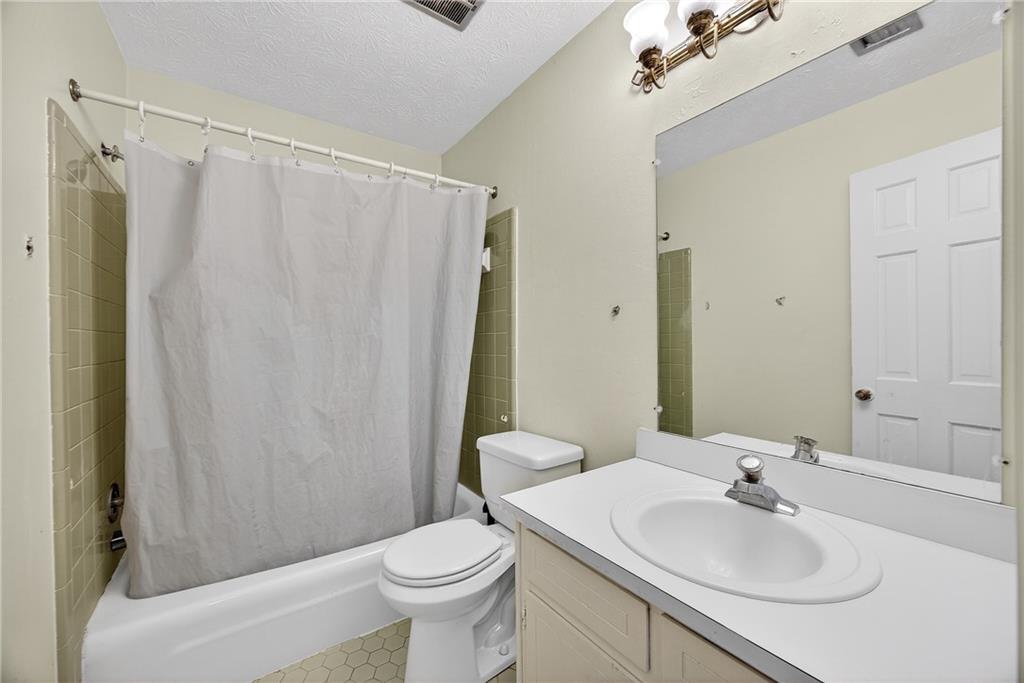 4673 Arrowhead Trail Southwest Lilburn, GA 30047 - Photo 21 of 28 a bathroom with a sink toilet and shower