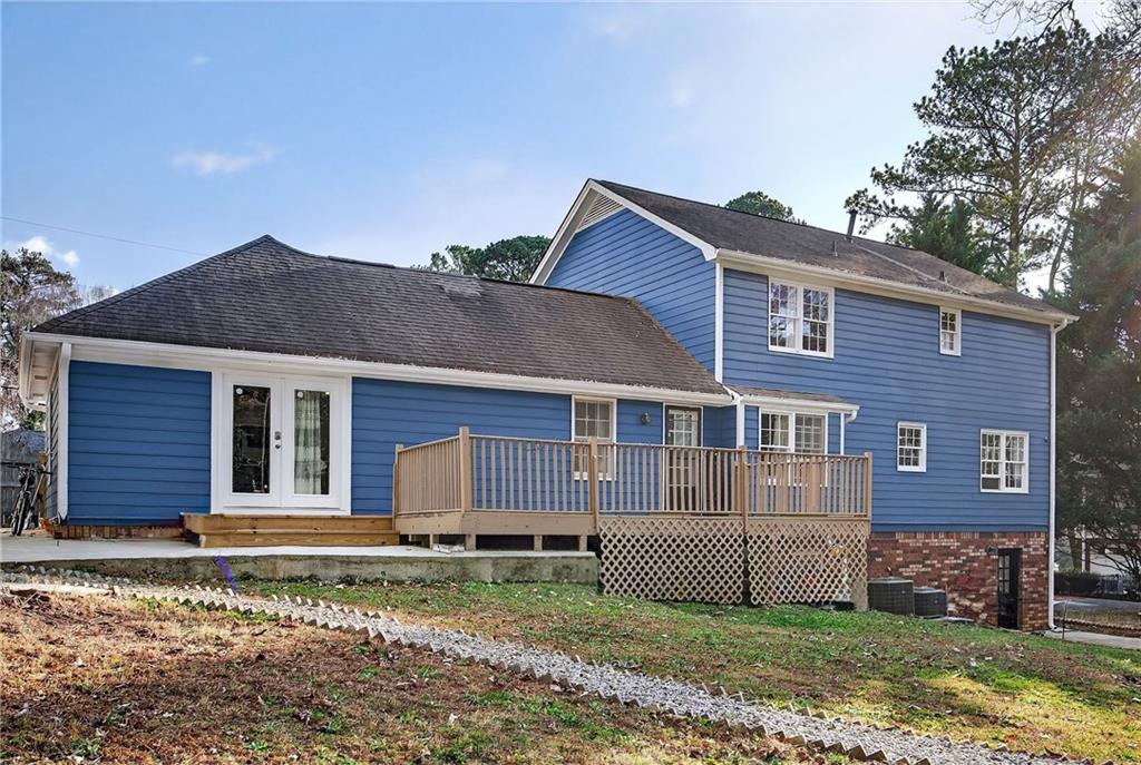 4673 Arrowhead Trail Southwest Lilburn, GA 30047 - Photo 25 of 28 a front view of a house with a yard