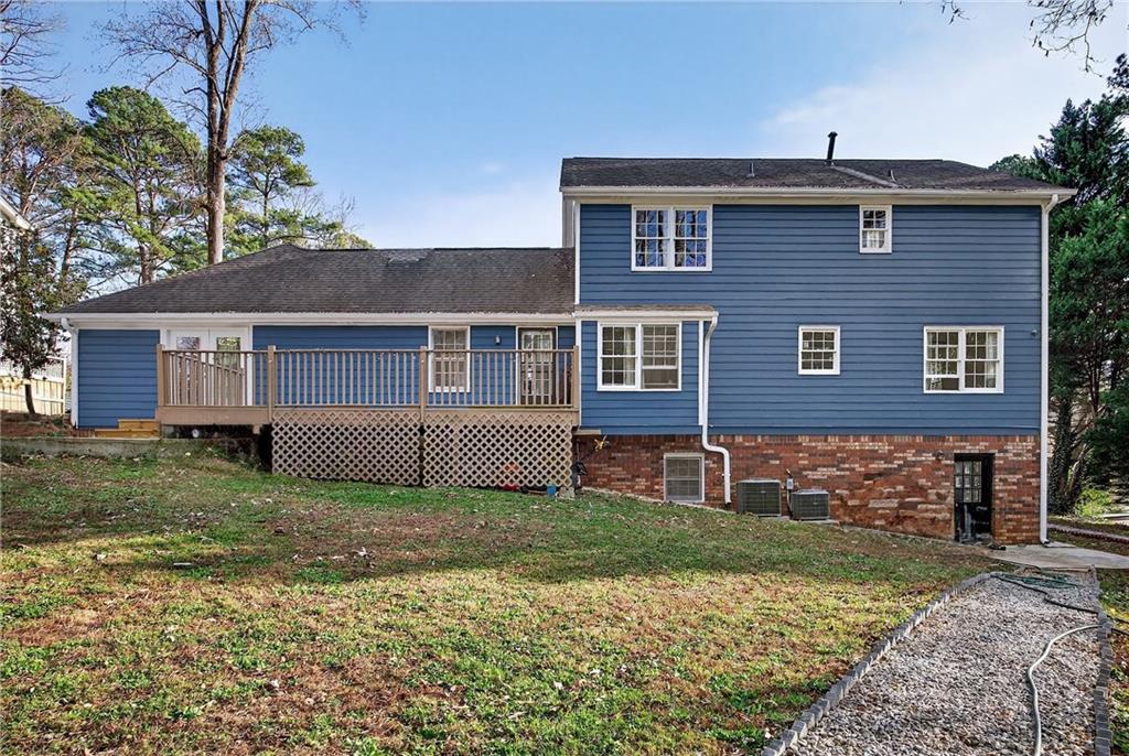 4673 Arrowhead Trail Southwest Lilburn, GA 30047 - Photo 26 of 28 a front view of a house with garden