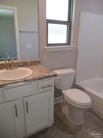 a white toilet sitting next to a bath tub shower