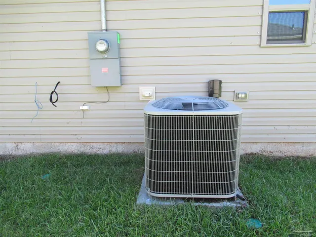 a view of backyard of house with green space