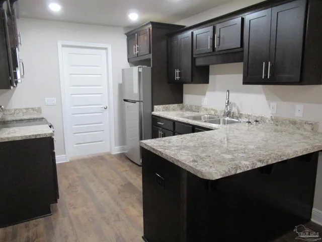 a kitchen with a sink stove and refrigerator