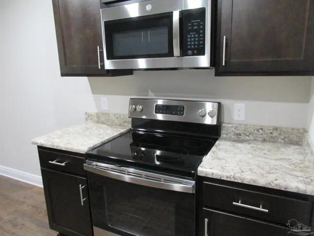 a kitchen with a stove and a microwave
