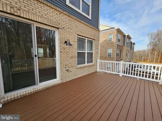 a view of a wooden deck and trees