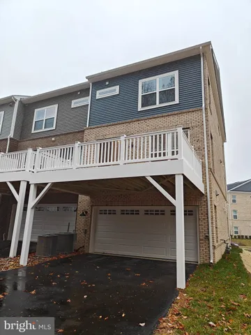 a kitchen with stainless steel appliances granite countertop a refrigerator a sink dishwasher a oven and a large island with wooden floor