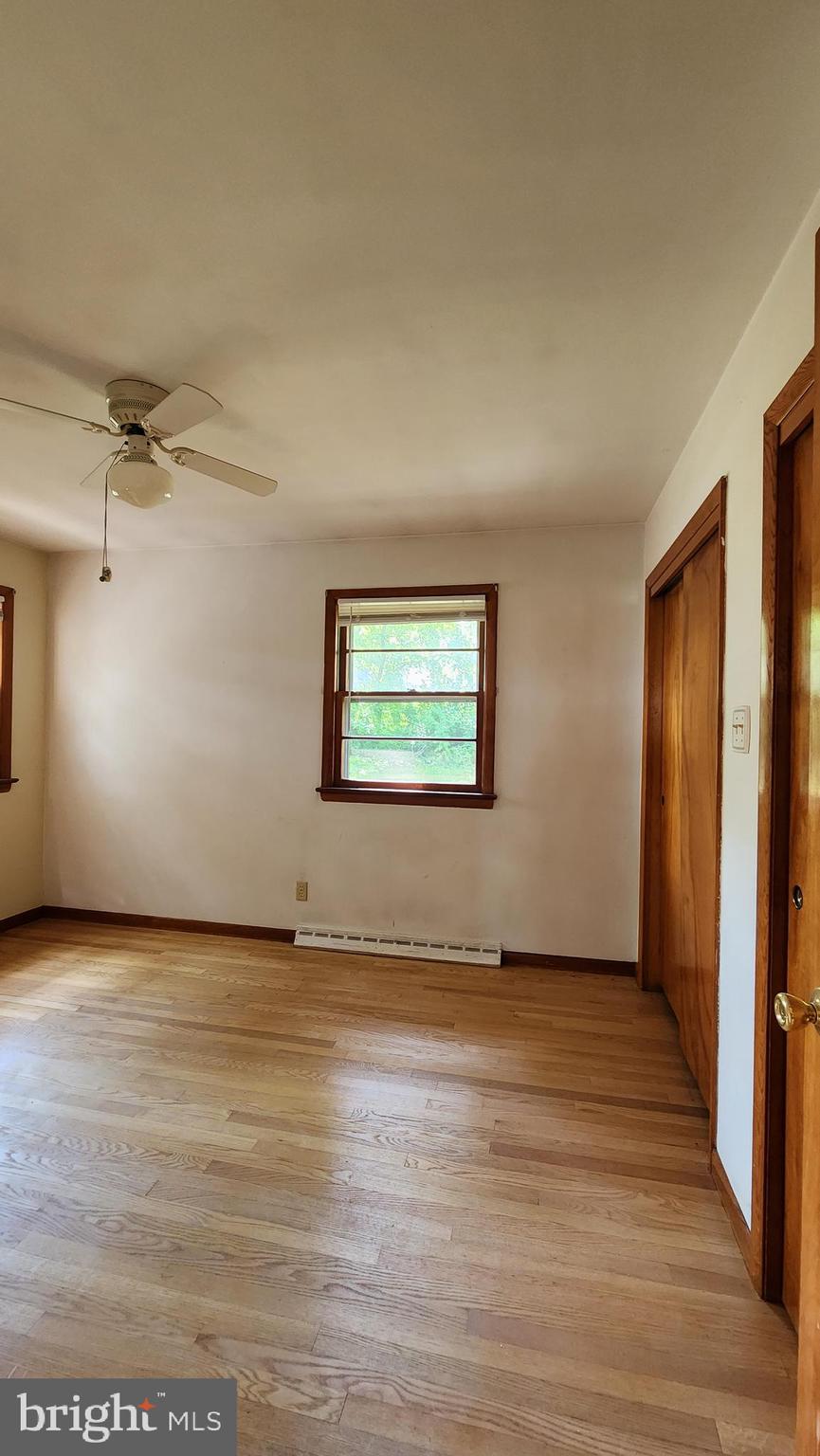 202 Holly Street Glassboro, NJ 08028 - Photo 11 of 23 an empty room with wooden floor cabinet and windows