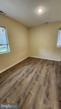 an empty room with wooden floor