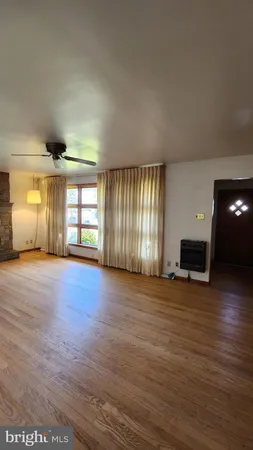 an empty room with windows and fireplace