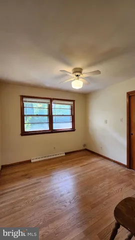 an empty room with wooden floor