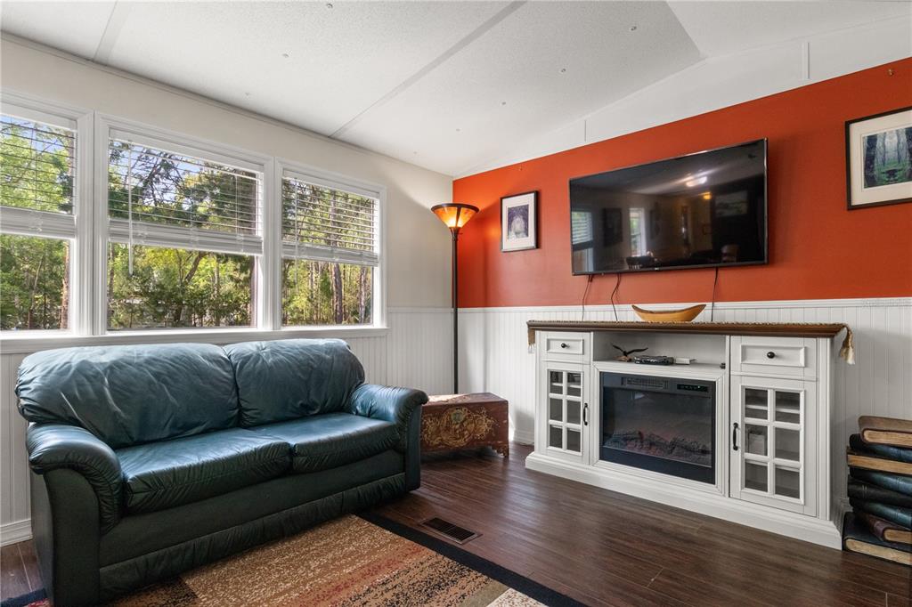 3650 176 Place Inglis, FL 34449 - Photo 16 of 49 a living room with stainless steel appliances furniture a fireplace and a flat screen tv