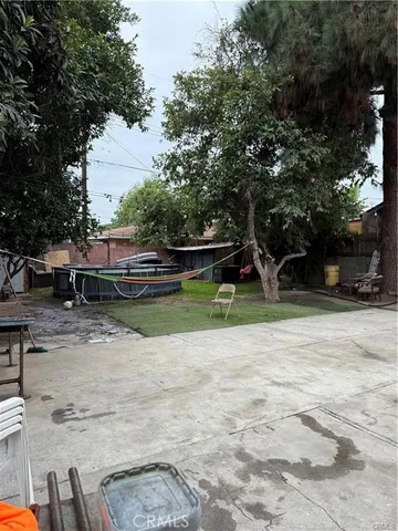 a view of backyard with a table and chairs