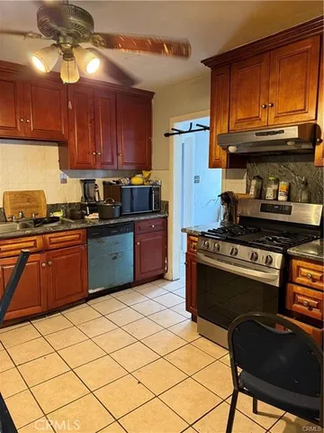 a kitchen with stainless steel appliances granite countertop a stove cabinets and refrigerator