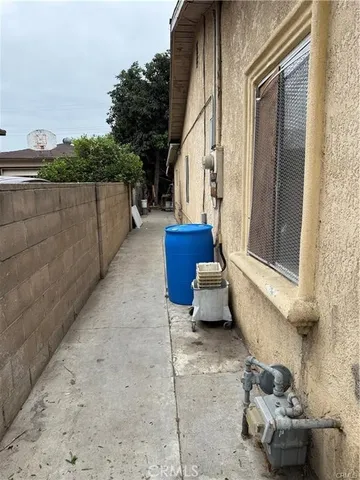 a view of a house with a chair and potted plants