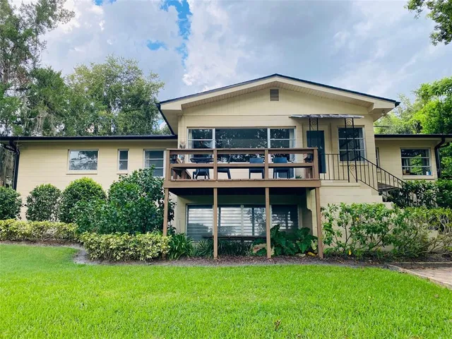 a front view of a house with a garden and plants