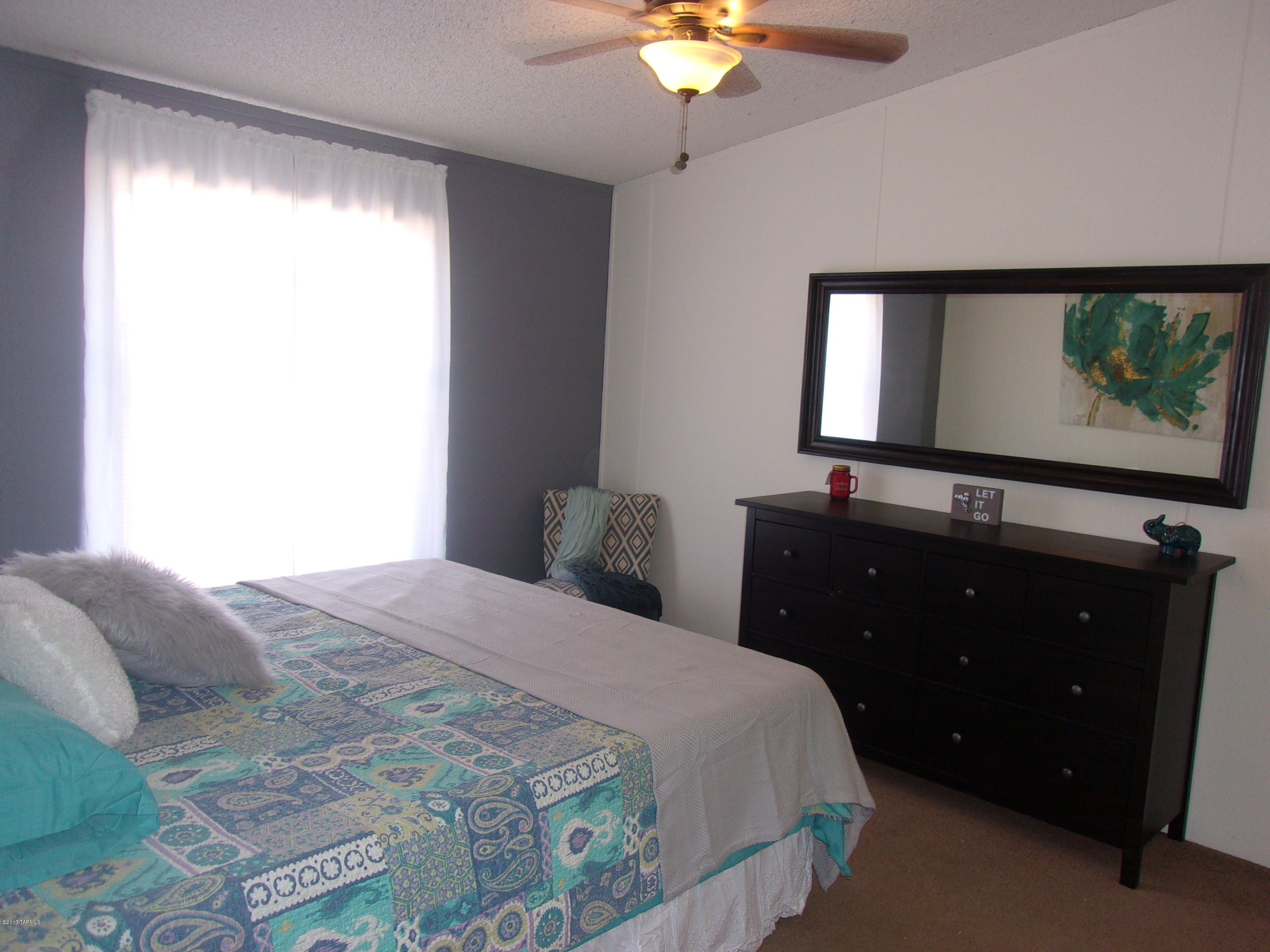 307 West King Road Tucson, AZ 85705 - Photo 3 of 17 a bedroom with a bed and a flat screen tv