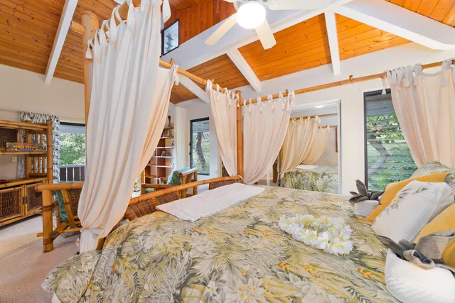 a view of a bedroom with a bed and furniture