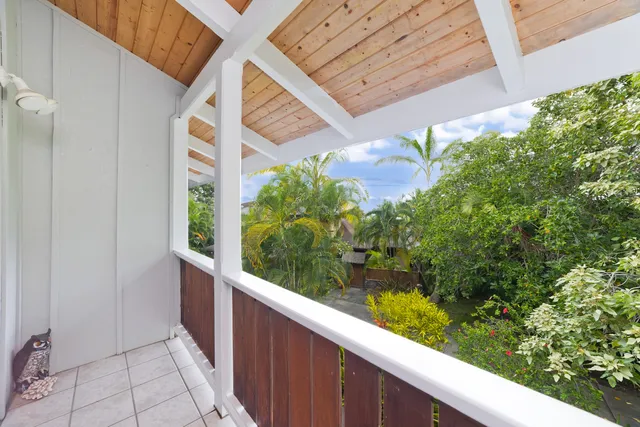 a view of a balcony with flower plants