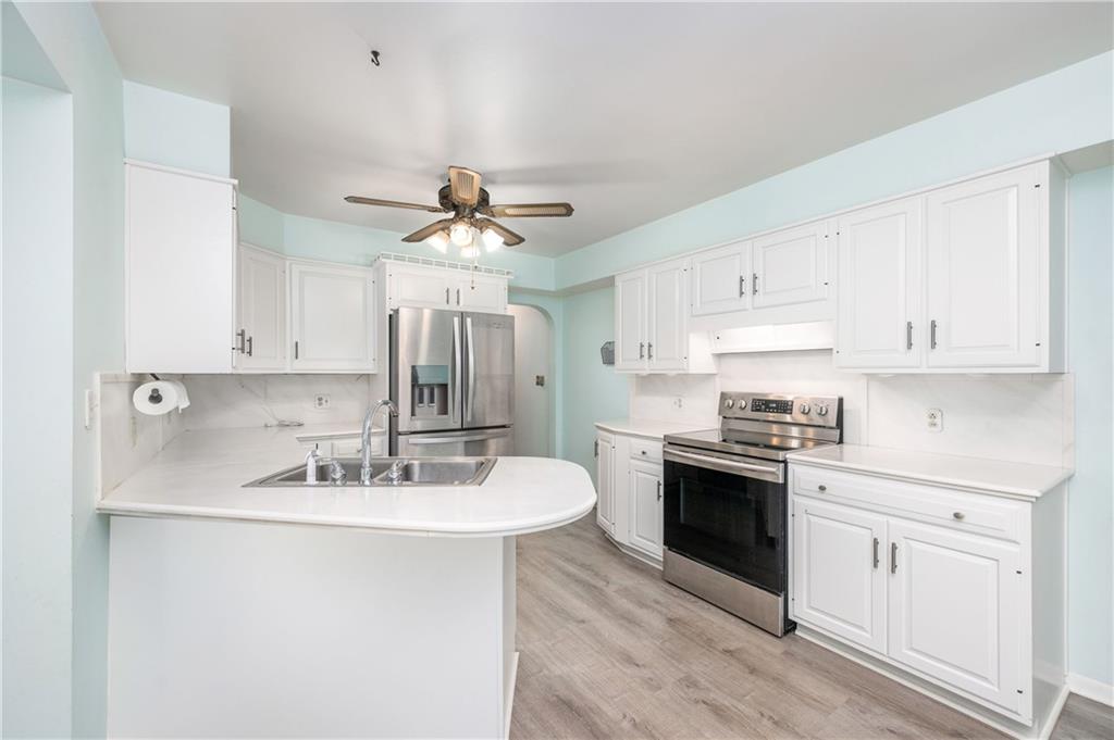 686 Christy Road Hermitage, PA 16148 - Photo 11 of 36 a kitchen with stainless steel appliances a sink stove and cabinets