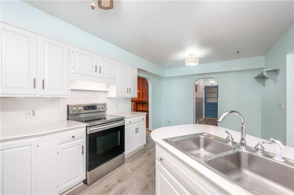 686 Christy Road Hermitage, PA 16148 - Photo 12 of 36 a kitchen with granite countertop a sink dishwasher stove and cabinets