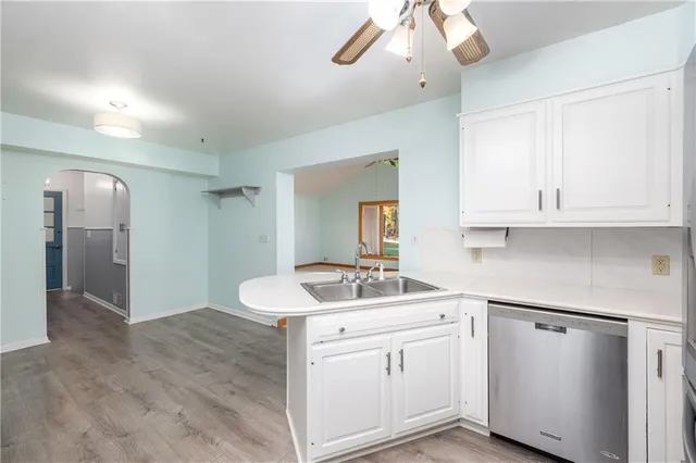 a kitchen with cabinets appliances and a sink