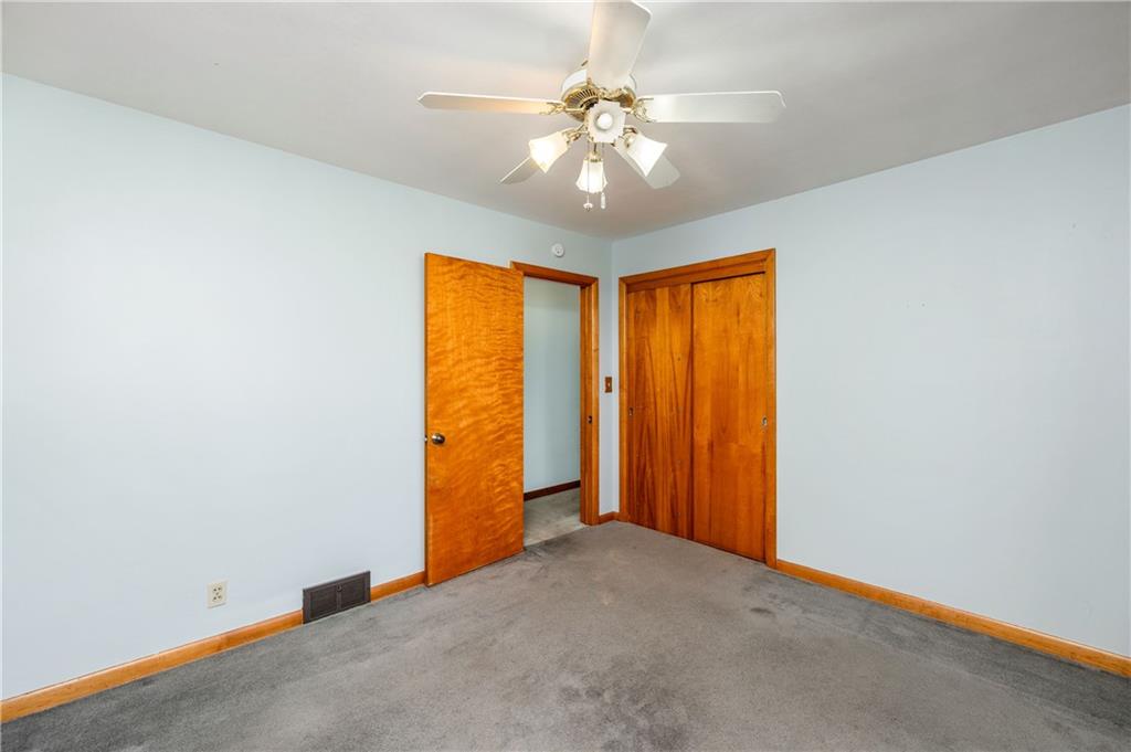 686 Christy Road Hermitage, PA 16148 - Photo 25 of 36 an empty room with a chandelier fan and windows