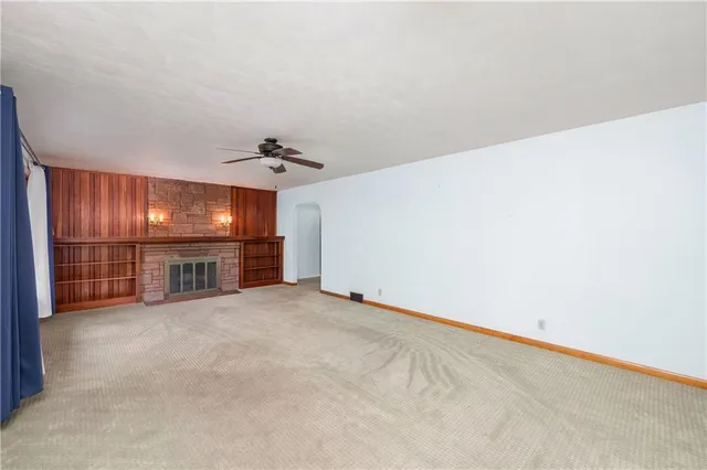 an empty room with a empty space and windows