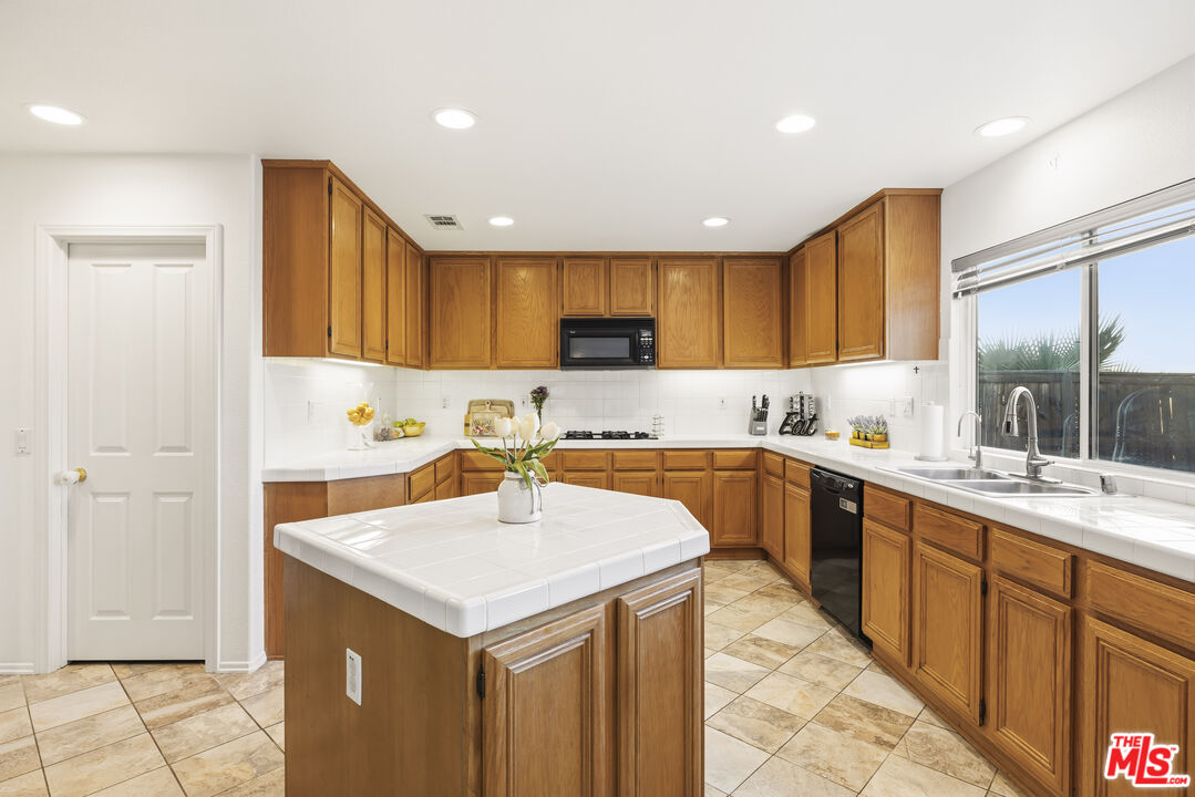 32610 Ridge Top Lane Castaic, CA 91384 - Photo 13 of 49 a kitchen with a sink a stove a refrigerator and a cabinets