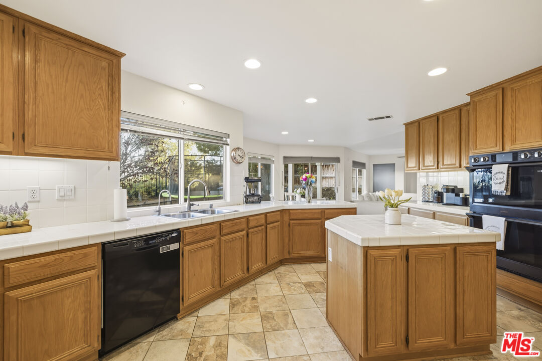 32610 Ridge Top Lane Castaic, CA 91384 - Photo 14 of 49 a kitchen with a sink stove and cabinets