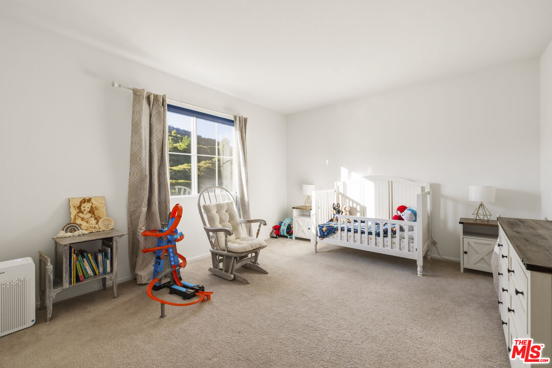 32610 Ridge Top Lane Castaic, CA 91384 - Photo 27 of 49 a living room with furniture a air conditioner and a wooden floor