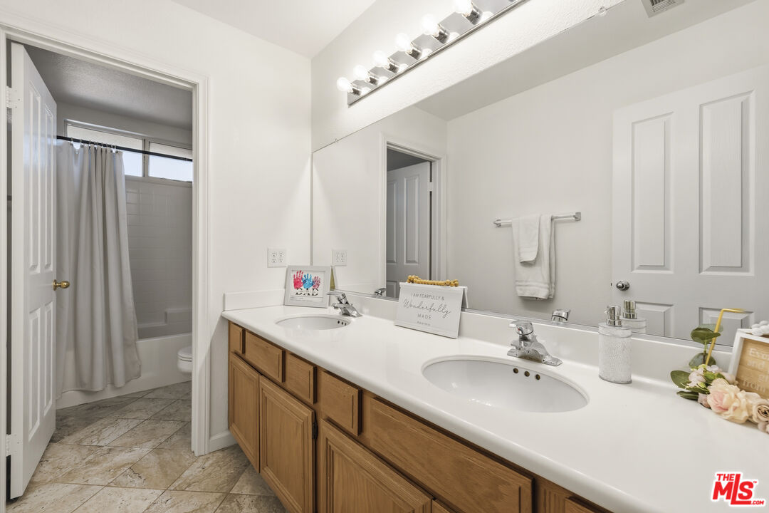 32610 Ridge Top Lane Castaic, CA 91384 - Photo 33 of 49 a bathroom with a sink and a mirror