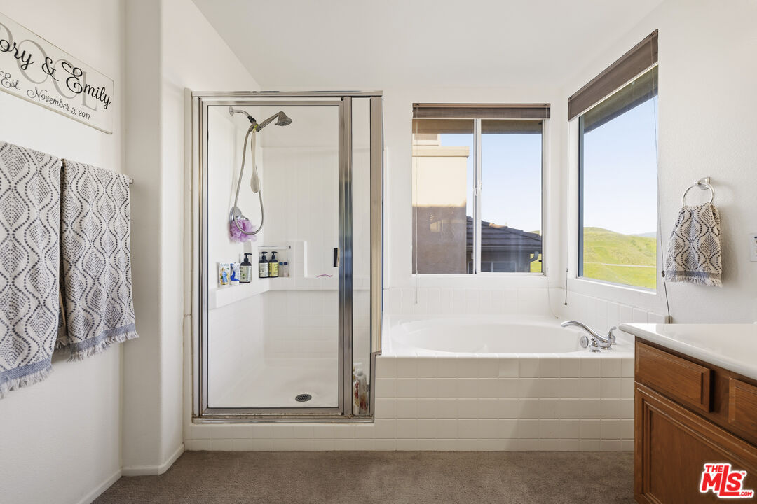 32610 Ridge Top Lane Castaic, CA 91384 - Photo 40 of 49 a bathroom with a bathtub and a shower