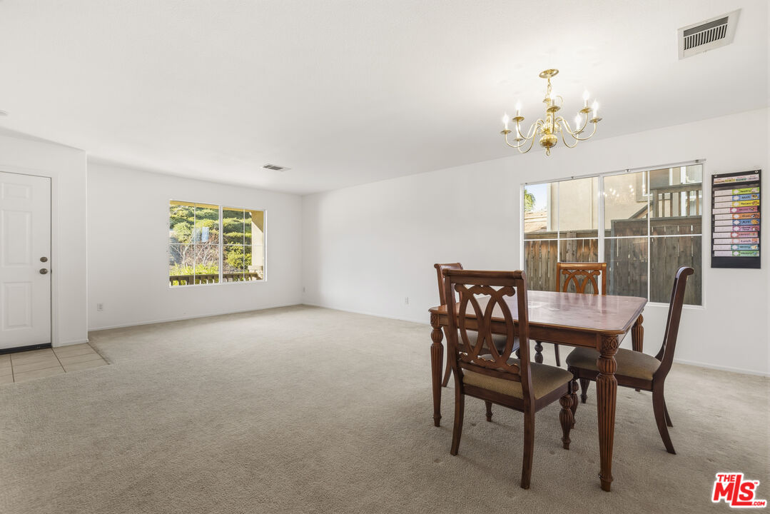 32610 Ridge Top Lane Castaic, CA 91384 - Photo 8 of 49 a view of a dining room with furniture wooden floor and a chandelier