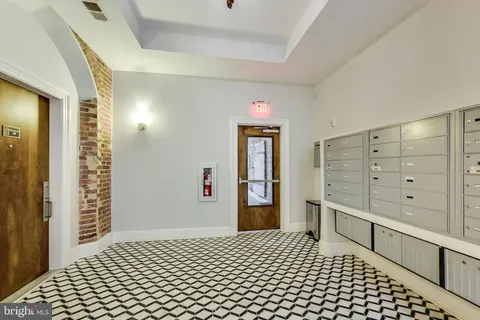 a bedroom with a dresser and a shower