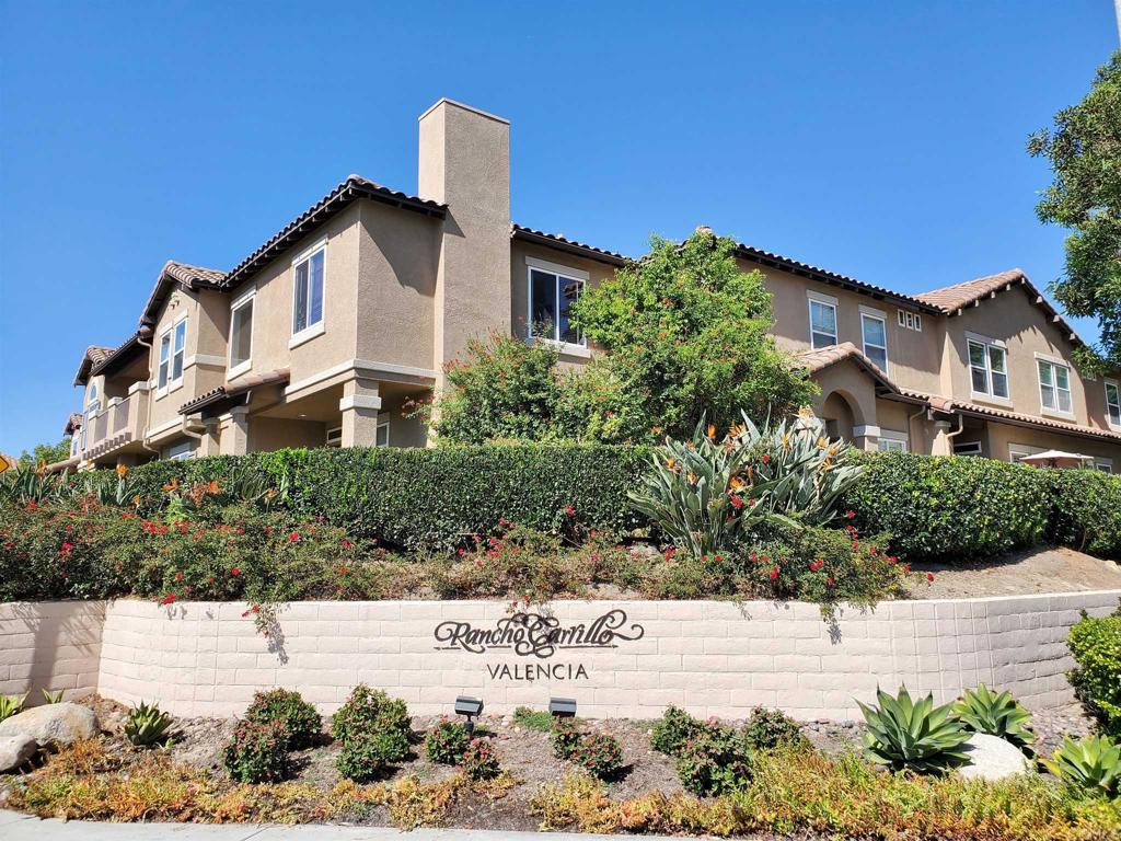 a view of white house with a yard and plants