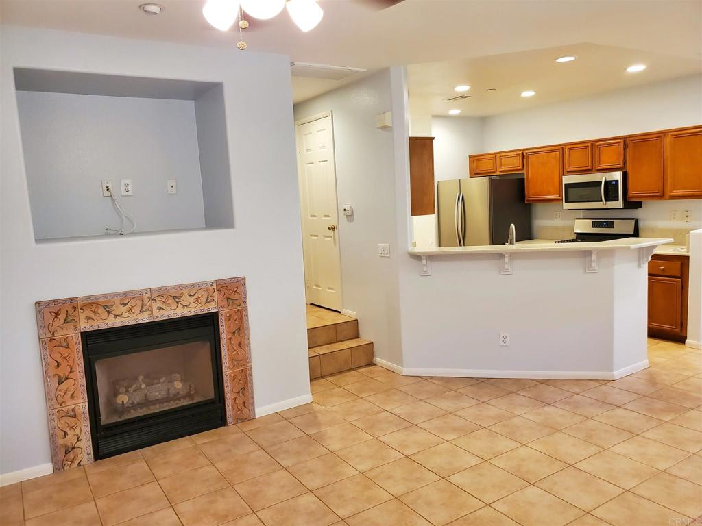 6116 Citracado Circle Carlsbad, CA 92009 - Photo 13 of 32 a view of a kitchen with furniture and a fireplace