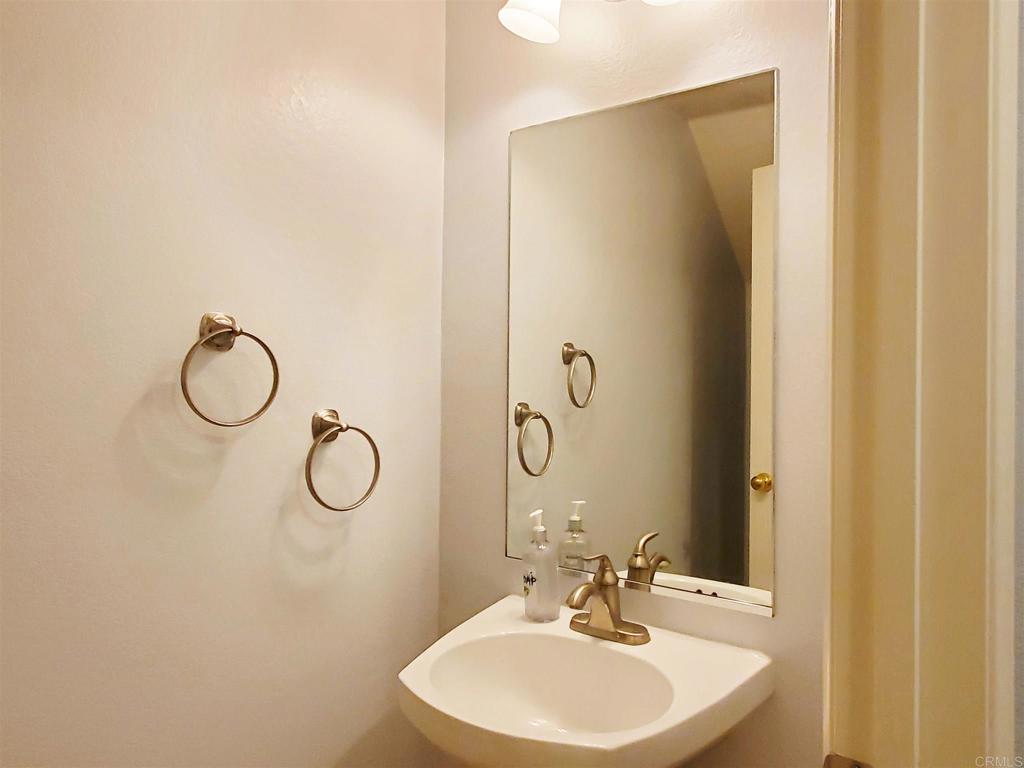 6116 Citracado Circle Carlsbad, CA 92009 - Photo 16 of 32 a bathroom with a sink and a mirror