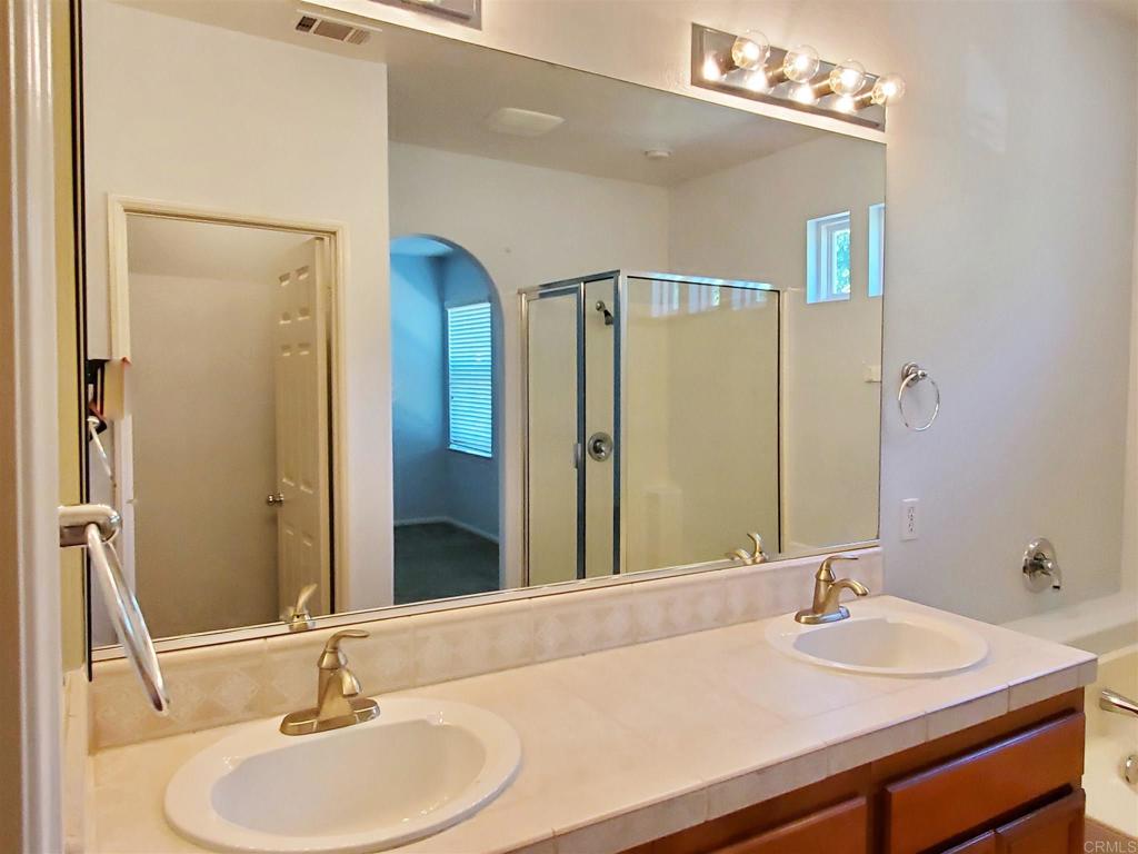 6116 Citracado Circle Carlsbad, CA 92009 - Photo 19 of 32 a bathroom with a sink and a mirror