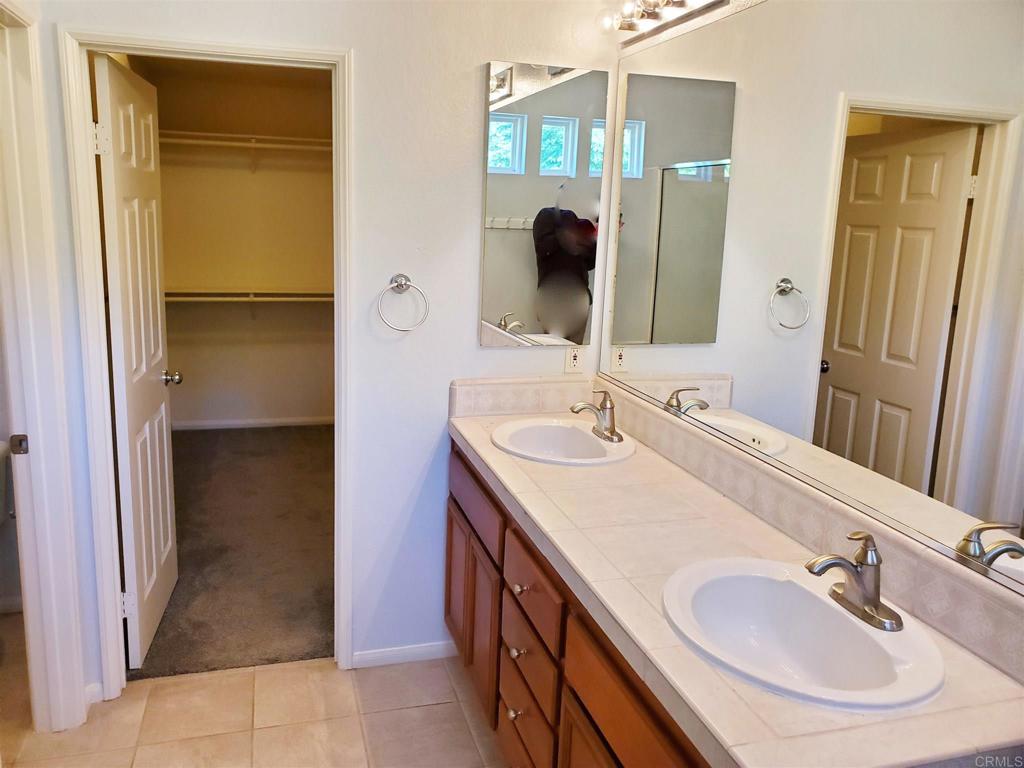 6116 Citracado Circle Carlsbad, CA 92009 - Photo 21 of 32 a bathroom with a sink and a mirror