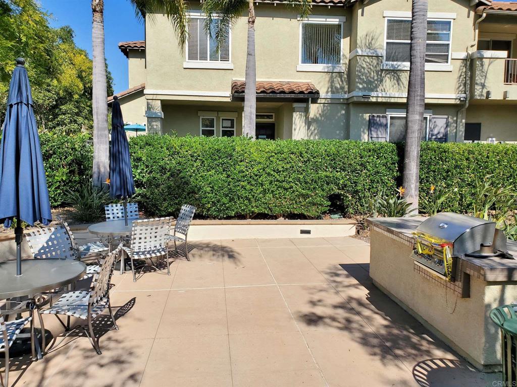 6116 Citracado Circle Carlsbad, CA 92009 - Photo 4 of 32 a view of a patio with couches table and chairs and potted plants