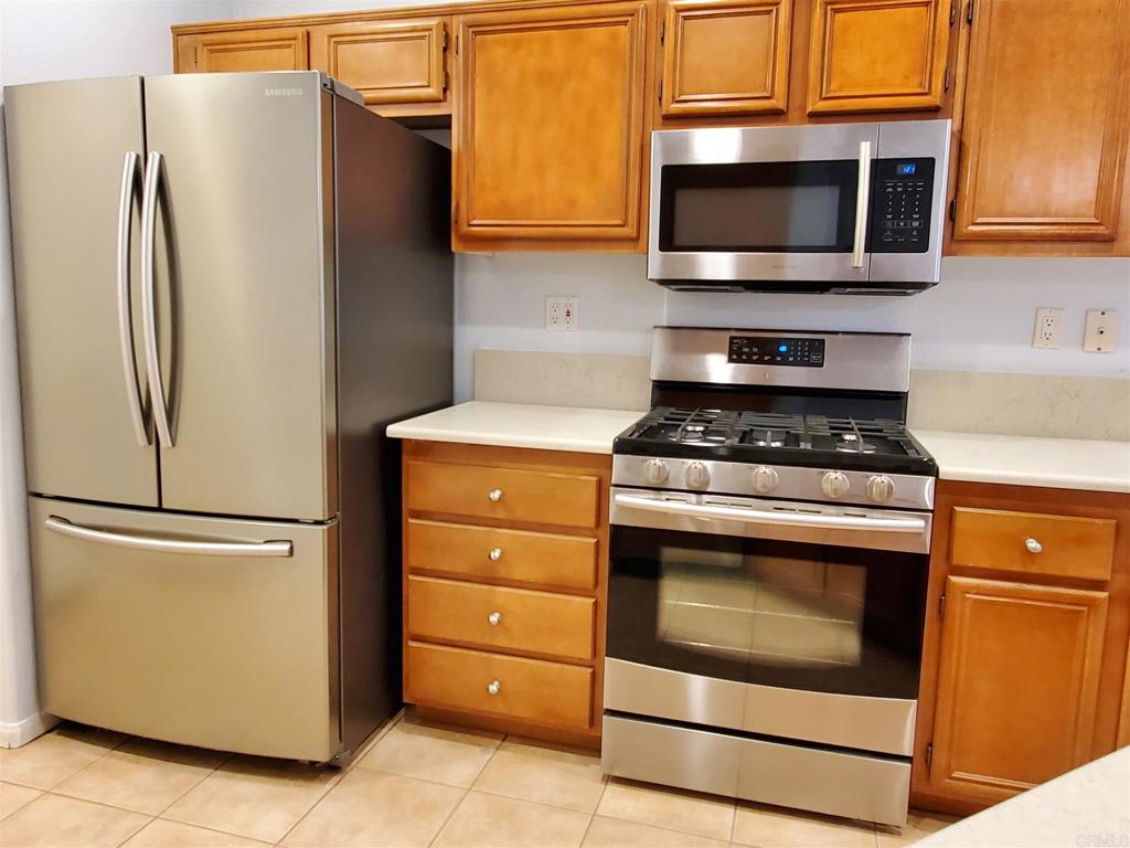 6116 Citracado Circle Carlsbad, CA 92009 - Photo 7 of 32 a kitchen with granite countertop cabinets and steel stainless steel appliances